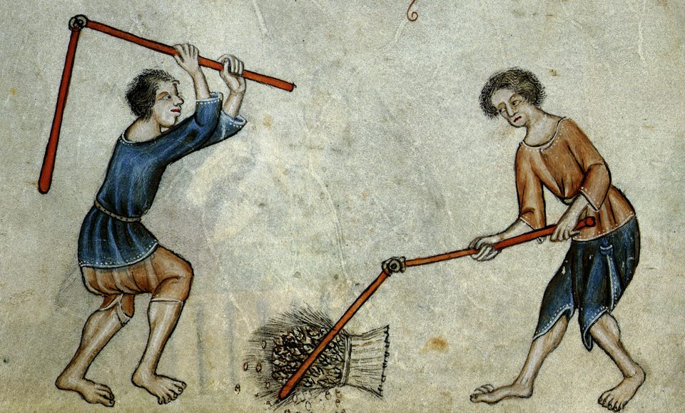 A fourteenth-century marginal painting of two men in tunics threshing a sheaf of corn with flails.